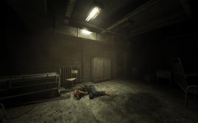 A man lies on the floor in an abandoned hospital. The light is dim and gloomy, and there is no one around.