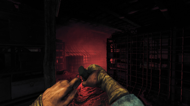 Screenshot from a first-person horror video game. In a dark, abandoned basement, there is a man with bandaged hands laying on the ground.